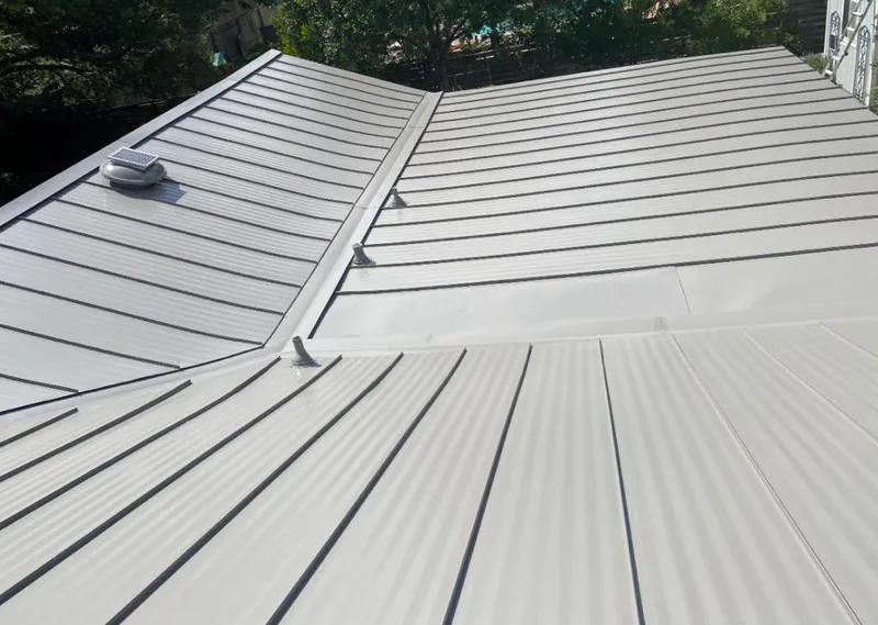 Solar attic fan installed on a metal roof for Roof Ventilation in Pimmit Hills